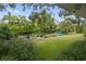 Private backyard oasis with lush landscaping and canal views at 4915 W Melrose N Ave, Tampa, FL 33629