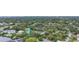 Aerial view of a waterfront home nestled among lush trees and other houses at 4915 W Melrose N Ave, Tampa, FL 33629