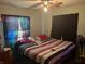 Spacious bedroom with a large bed and window curtains at 1528 Stevensons Dr, Clearwater, FL 33755