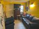 Cozy living room featuring a leather sofa and armchair at 1528 Stevensons Dr, Clearwater, FL 33755