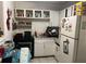 Small kitchen with white cabinets and appliances at 1528 Stevensons Dr, Clearwater, FL 33755