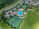 Aerial view showing community pool, tennis courts, playground, and parking at 3232 Gianna Way, Land O Lakes, FL 34638