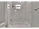 Clean bathroom with a bathtub and marble-style tile shower at 2604 N 29Th St, Tampa, FL 33605