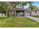 Modern gray house with a covered porch and driveway at 2604 N 29Th St, Tampa, FL 33605