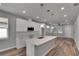 Open concept kitchen with white cabinets and island at 2604 N 29Th St, Tampa, FL 33605