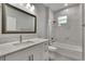 Modern bathroom with white vanity, bathtub, and marble tile at 2604 N 29Th St, Tampa, FL 33605