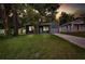 Modern gray house with a covered porch and driveway at dusk at 2604 N 29Th St, Tampa, FL 33605