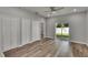 Bright bedroom with wood-look floors and sliding glass doors to backyard at 2604 N 29Th St, Tampa, FL 33605