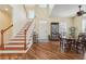 Bright entryway with hardwood floors, staircase, and a view of the dining room at 5413 Cafrey Pl, Apollo Beach, FL 33572