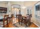 Open dining area connecting kitchen to front living room; hardwood floors and a dining table at 12314 Lake Jovita Blvd, Dade City, FL 33525