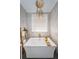 Modern bathtub with gold fixtures, decorative ladder, and plenty of light from the window at 180 Keystone Palms Blvd, Tarpon Springs, FL 34688