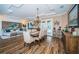 A dining room with views of the pool and a dining room set for six people is ideal for dinner parties at 180 Keystone Palms Blvd, Tarpon Springs, FL 34688