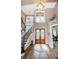 Inviting home foyer featuring high ceilings, natural light, wood floors and staircase at 180 Keystone Palms Blvd, Tarpon Springs, FL 34688