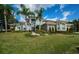 Stunning two-story home boasting stone accents, lush landscaping, and towering palm trees at 180 Keystone Palms Blvd, Tarpon Springs, FL 34688