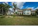 Well-maintained lawn and landscaping leading up to the exterior of this two-story home at 180 Keystone Palms Blvd, Tarpon Springs, FL 34688
