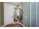 Hallway featuring a mirrored wall, with a view into the main bathroom with dual vanities and mirrors at 180 Keystone Palms Blvd, Tarpon Springs, FL 34688