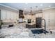 Open kitchen featuring custom cabinets, center island, and stainless steel appliances at 180 Keystone Palms Blvd, Tarpon Springs, FL 34688