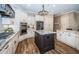 Spacious open kitchen featuring an island, stainless steel appliances and stone countertops at 180 Keystone Palms Blvd, Tarpon Springs, FL 34688