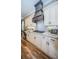 Beautiful kitchen featuring stone countertops, custom cabinets, and range hood at 180 Keystone Palms Blvd, Tarpon Springs, FL 34688