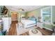Bright main bedroom with accent wall, tray ceiling, and seating area, offering ample natural light at 180 Keystone Palms Blvd, Tarpon Springs, FL 34688