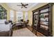 Inviting home office with built-in bookshelves, a cozy desk, and plenty of natural light at 180 Keystone Palms Blvd, Tarpon Springs, FL 34688