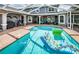 A large pool with a patio and outdoor furniture perfect for entertaining or relaxing by the water at 180 Keystone Palms Blvd, Tarpon Springs, FL 34688