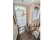 View from the top of the staircase showing the entry door and beautiful chandelier at 180 Keystone Palms Blvd, Tarpon Springs, FL 34688