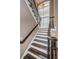 Elegant staircase featuring hardwood steps, white risers, and wrought iron balusters at 180 Keystone Palms Blvd, Tarpon Springs, FL 34688