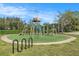 Community playground with playset, slides, and swings at 3664 Darston St, Palm Harbor, FL 34685