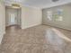 Open living room with tile flooring and access to front door at 4417 Shrewbury Pl, Land O Lakes, FL 34638