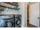 Laundry room with washer, dryer, and ample shelving for storage at 180 Keystone Palms Blvd, Tarpon Springs, FL 34688