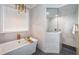 Bathroom with soaking tub, walk-in shower, and marble tile at 180 Keystone Palms Blvd, Tarpon Springs, FL 34688