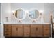 Double vanity bathroom with modern light fixtures and quartz countertops at 180 Keystone Palms Blvd, Tarpon Springs, FL 34688