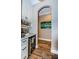 Hallway with hardwood floors, artwork, and access to other rooms at 180 Keystone Palms Blvd, Tarpon Springs, FL 34688