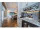 Elegant wet bar with granite countertops, wine rack, and mini-refrigerator at 180 Keystone Palms Blvd, Tarpon Springs, FL 34688