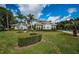 Stunning curb appeal with lush landscaping at 180 Keystone Palms Blvd, Tarpon Springs, FL 34688