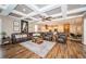 Large living area with hardwood floors, coffered ceilings, and open floor plan at 180 Keystone Palms Blvd, Tarpon Springs, FL 34688
