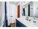 Navy vanity and walk-in shower with blue tile at 180 Keystone Palms Blvd, Tarpon Springs, FL 34688