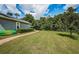Brick pathway beside home, leading to backyard, kayaks visible at 180 Keystone Palms Blvd, Tarpon Springs, FL 34688