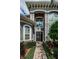 Two-story home with gray exterior, double doors, and landscaping at 180 Keystone Palms Blvd, Tarpon Springs, FL 34688