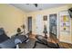 In-home gym with exercise equipment and adjacent bathroom at 180 Keystone Palms Blvd, Tarpon Springs, FL 34688
