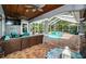 Spacious pool area with covered patio and outdoor furniture at 180 Keystone Palms Blvd, Tarpon Springs, FL 34688