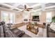 Open living room with hardwood floors, fireplace, and access to the backyard at 180 Keystone Palms Blvd, Tarpon Springs, FL 34688