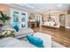 Open dining area with hardwood floors, chandelier, and access to the pool area at 180 Keystone Palms Blvd, Tarpon Springs, FL 34688