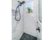 Walk-in shower with marble walls and pebble floor at 180 Keystone Palms Blvd, Tarpon Springs, FL 34688