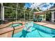 Relaxing spa with a floating lounger and screened enclosure at 180 Keystone Palms Blvd, Tarpon Springs, FL 34688
