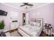 Guest bedroom with a queen-size bed and light purple walls at 180 Keystone Palms Blvd, Tarpon Springs, FL 34688
