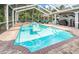 Inviting swimming pool with a brick deck and screened enclosure at 180 Keystone Palms Blvd, Tarpon Springs, FL 34688