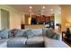 Bright living room featuring a comfortable sectional sofa and access to the kitchen at 29731 Chapel Park Dr, Wesley Chapel, FL 33543