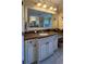 Bathroom with double vanity and granite countertops at 29731 Chapel Park Dr, Wesley Chapel, FL 33543